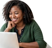 An educator smiling while working at a laptop